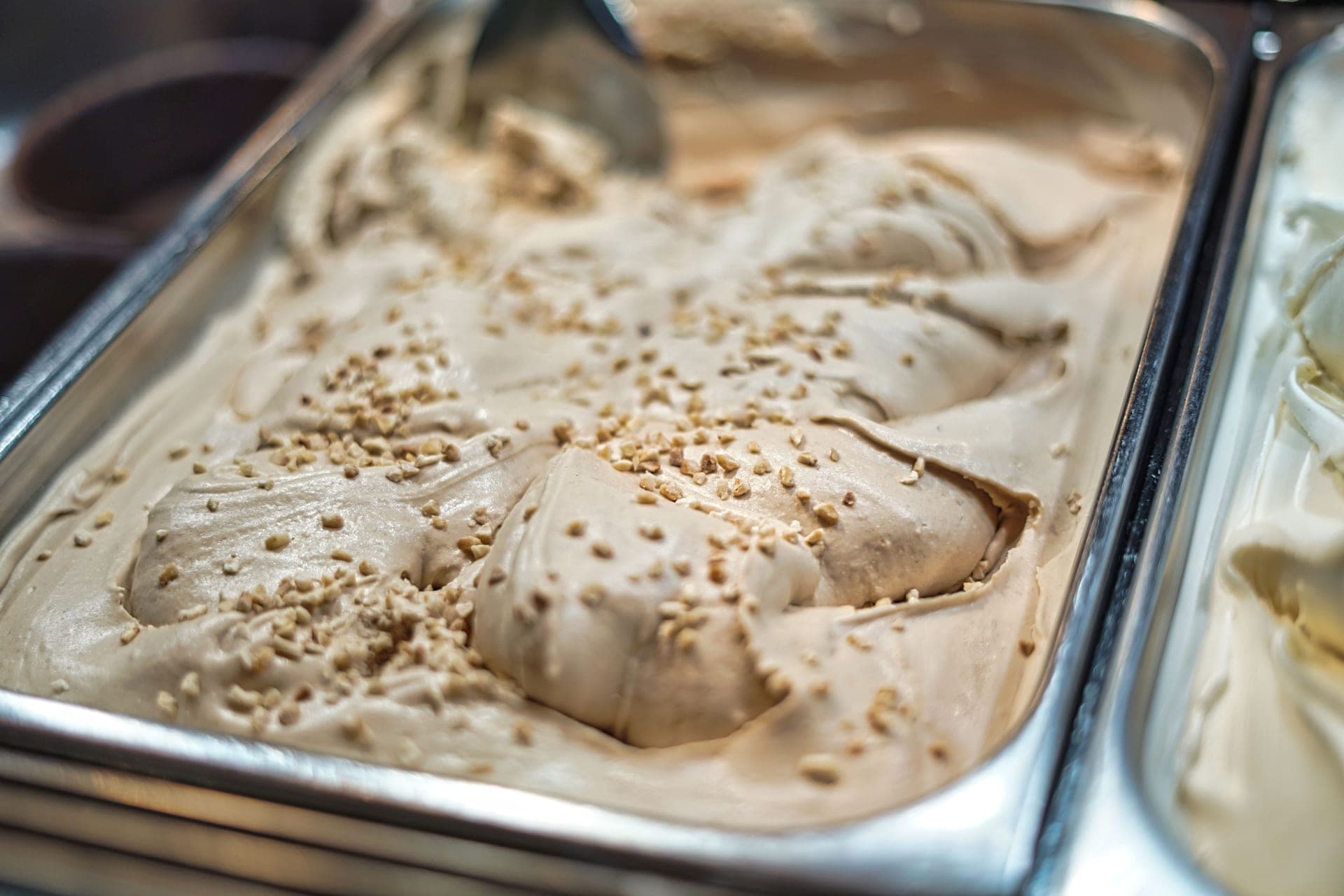 Cream, milk, sugar and vanilla pods laid out on a counter